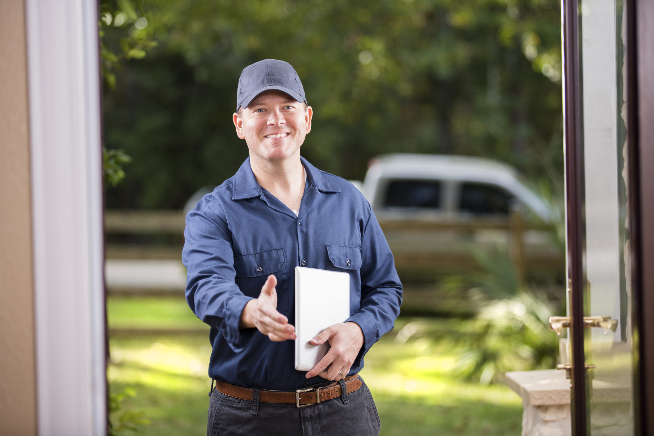 Service Industry: Repairman at customer's front door. Digital tablet. Handshake.
